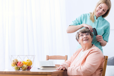 caregiver taking care of senior woman